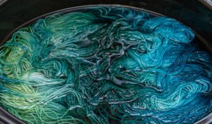 dye solution over the yarn